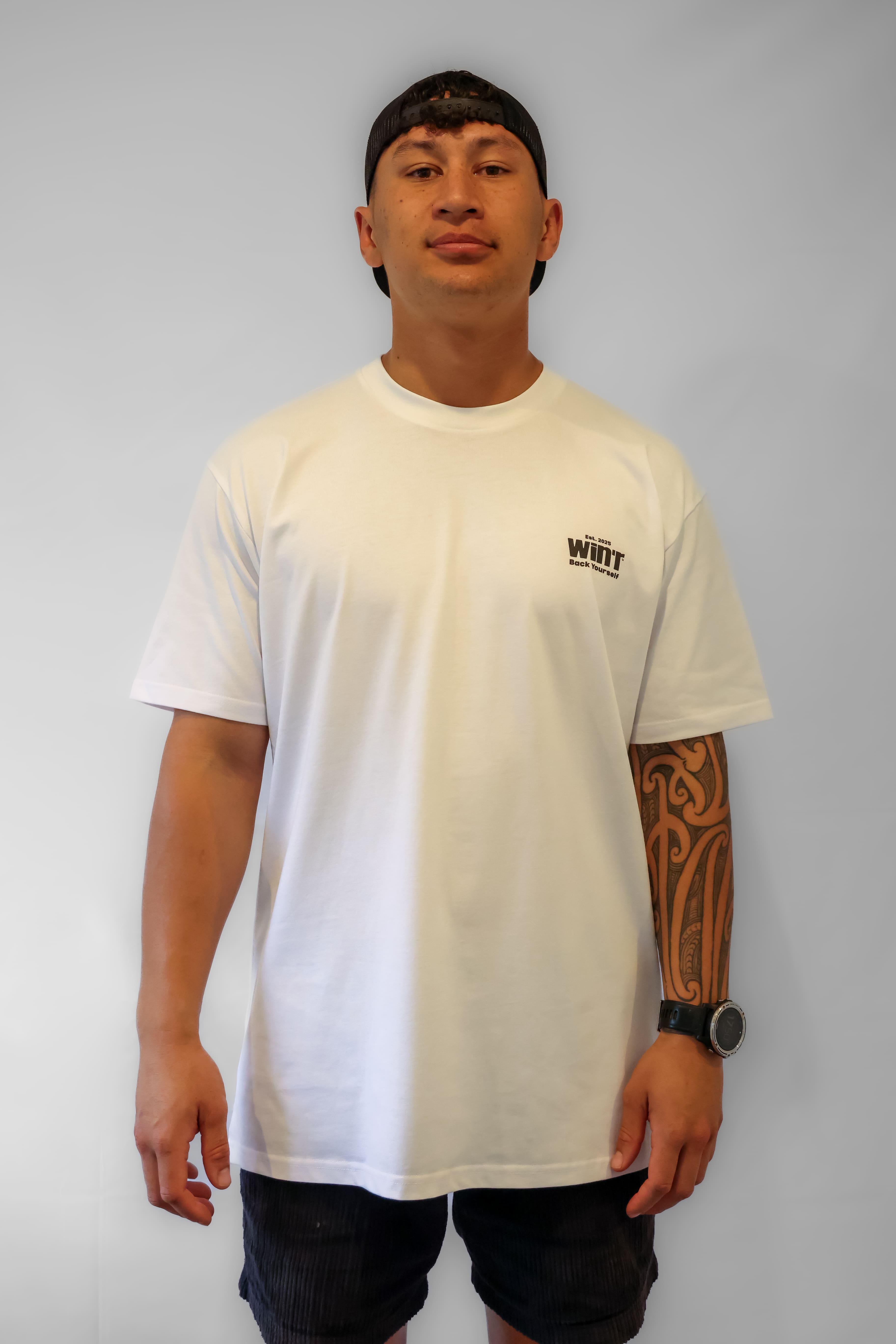 Person wearing a white Winr bold print t-shirt with logo, premium cotton streetwear tee on a grey background.